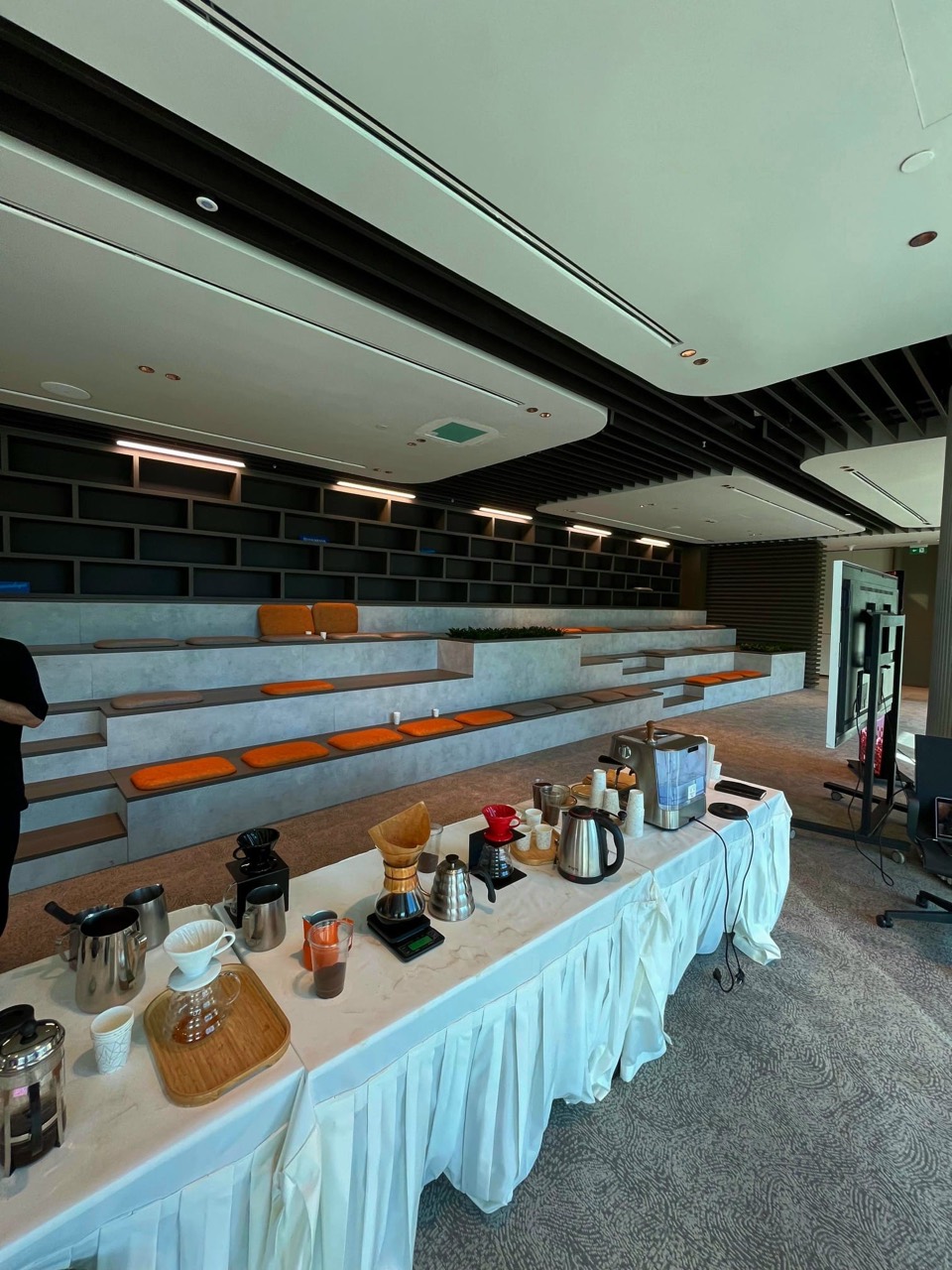 Filter coffee brewers, pitchers and scales arranged on a workshop table